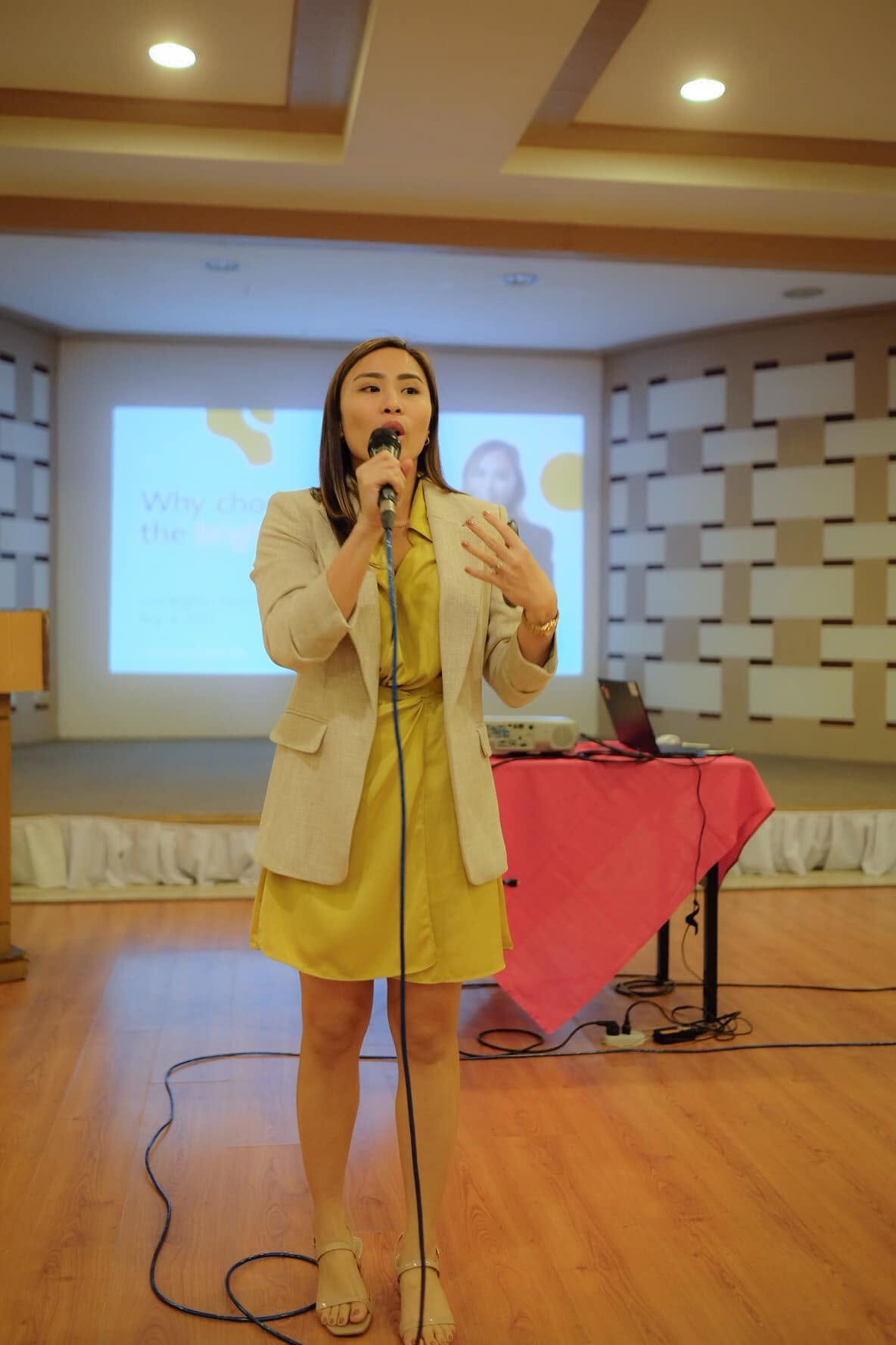 On stage or leading a workshop, mid-gesture